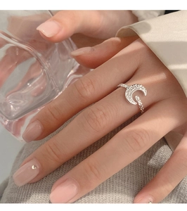 Detailed close-up of crescent moon ring featuring hand-hammered texture and silver finish