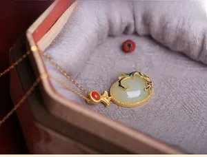 Macro shot of Hetian jade pendant with blue cold enamel floral patterns in a jewelry box