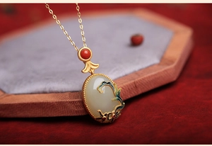 Close-up of vintage Hetian jade pendant with blue enamel cloud pattern on gold chain