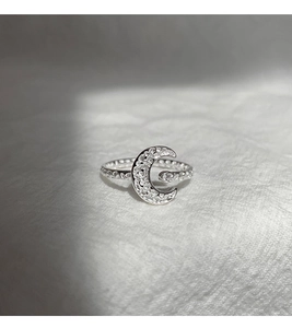 Macro view of textured crescent moon ring with micro-set white cubic zirconia stones