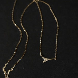 Elegant gold Eiffel Tower pendant necklace with sparkling crystals on a fine chain