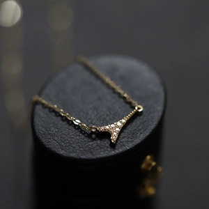 Eiffel Tower pendant necklace in gold finish with sparkling crystals on black display