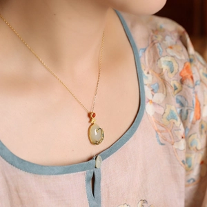 Elegant Chinese gold necklace with white jade pendant and blue enamel detailing