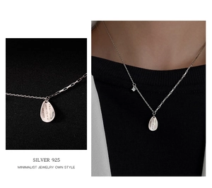 Close-up of 925 silver water drop necklace featuring engraved pendant and zircon accent