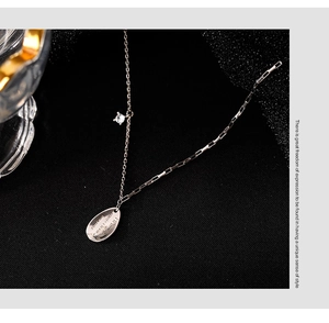 Detail of silver water-drop pendant with 'I will miss you' engraving and zircon accent