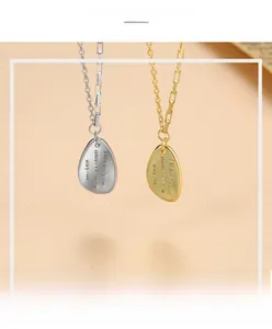 Detailed close-up of water drop pendants with engraved text and zircon stitch chain