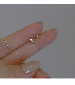 Detailed close-up of olive green crystal stud earrings with gold plating and silver ring