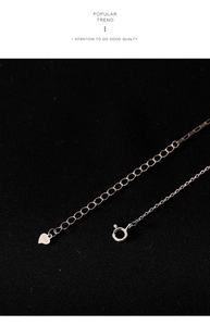 Macro shot of S925 sterling silver lobster clasp and heart pendant on water drop necklace
