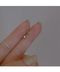Close-up of olive green marquise crystal stud earrings with a gold-tone claw setting