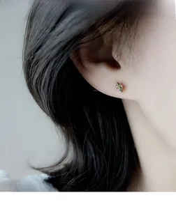 Close-up of olive green marquise crystal stud earring on model for elegant look