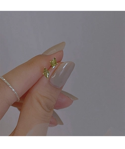 Close-up of small olive green marquise-cut crystal earrings held between fingers