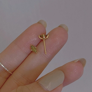 Handheld view of olive green marquise crystal stud earrings with gold plating