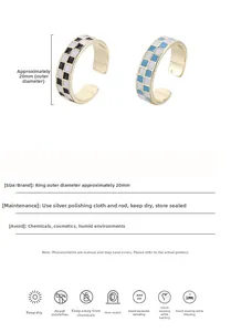 Detail of checkered enamel open rings with 20mm outer diameter in black and blue