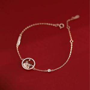Rose gold tiger zodiac bracelet with red circular charm and sparkling crystals for women