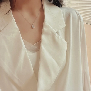 Dettaglio di una collana con pendente quadrato e micro-pavé di pietre in zirconite
