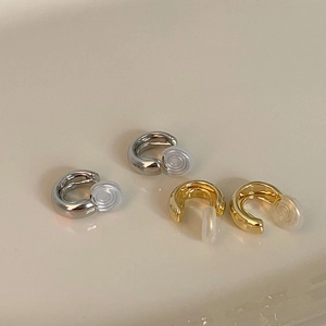 Minimalist gold and silver C-shaped ear cuffs with soft silicone pads in four pieces