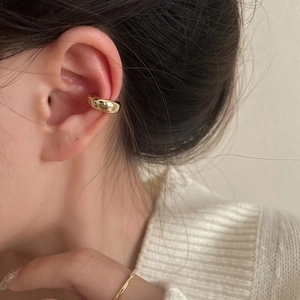 Minimalist gold ear cuff earring shown on model for a sleek, elegant jewelry look