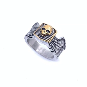 Detailed macro view of punk skull ring featuring gold relief on a silver textured band