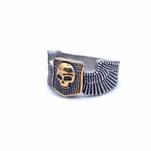 Detail view of gothic skull ring with vintage silver wings and gold skull accent