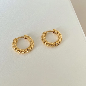 Minimalist twisted rope hoop earrings in gold-tone finish with a polished metallic texture