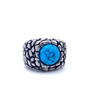Detailed view of the fish scale textured steel band with a turquoise inlay