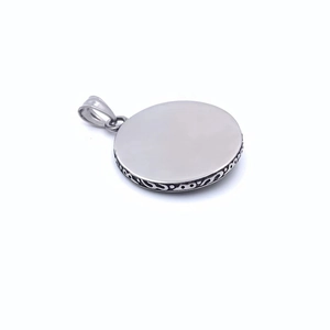 Detailed side view of the round sunflower pendant featuring ornate relief patterns on the edge