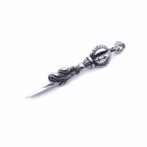 Macro shot of silver vajra pestle pendant with intricate religious embossed patterns