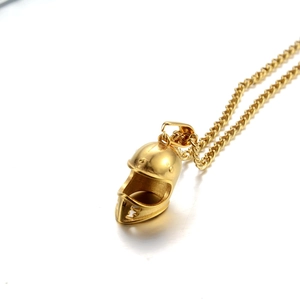 Golden Spartan helmet pendant necklace with a Cuban chain for men on a clean white background