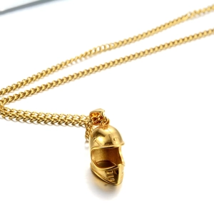 Golden motorcycle helmet pendant necklace with polished finish and curb chain