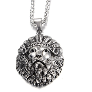 Detailed macro shot of vintage lion head pendant with intricate feathered crown detail