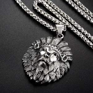Macro detail of antique silver lion head pendant with Indian crown and wheat chain