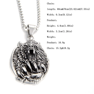 Macro detail of retro wolf head pendant and cross pattern chain in stainless steel