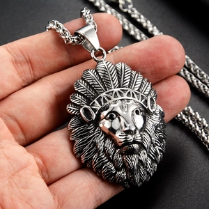 Detailed view of the Indian lion head pendant with feather headdress in antique silver