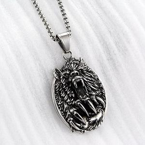 Detailed close-up of a vintage-style roaring bear pendant on a stainless steel box chain