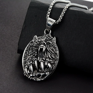 Macro detail of retro wolf head pendant on black stone showcasing the punk vintage finish
