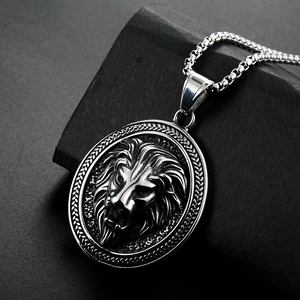 Detailed macro side view of vintage lion head relief pendant on textured dark stone