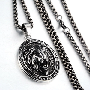 Macro shot of stainless steel lion head pendant with polished box chain necklace