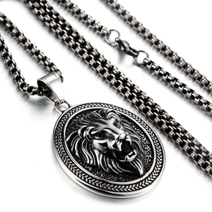 Macro view of vintage silver lion head pendant with textured steel square pearl chain