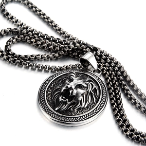 Macro shot of vintage lion head pendant in titanium steel with detailed retro carving