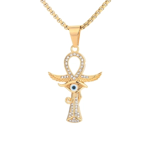 Detailed macro view of gold Ankh and Eye of Horus pendant with shimmering rhinestones