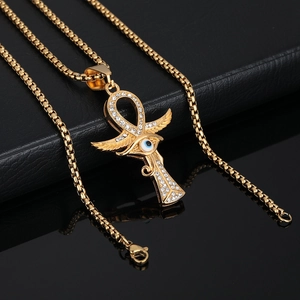 Gold plated Ankh cross necklace with Horus eye and wings set on black leather background