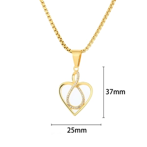 Golden heart necklace with infinity symbol and white crystals on a white background