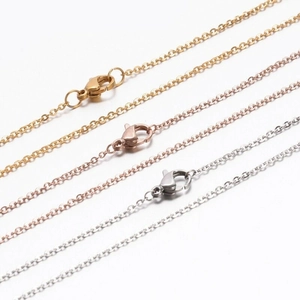 Detailed view of gold, rose gold and silver stainless steel O-chains with lobster clasps