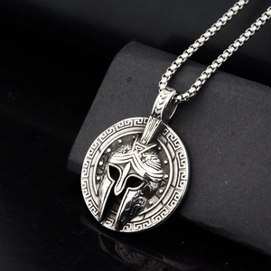 Macro shot of vintage silver Spartan helmet relief pendant with Greek fret edge detail