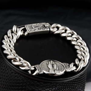 Vintage silver Cuban chain bracelet featuring praying hands medallion and Greek key details