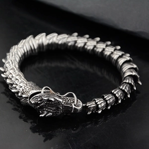 Detailed view of retro dragon head clasp and scales on vintage stainless steel bracelet