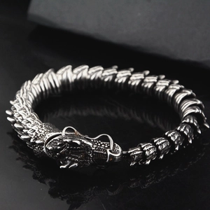 Macro shot of retro stainless steel dragon bone bracelet with detailed dragon head clasp