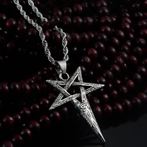 Detailed close-up of silver steel pentagram and Eye of Horus pendant on twisted chain