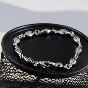 Vintage silver evil eye bracelet with oval engraved links and lobster clasp closure