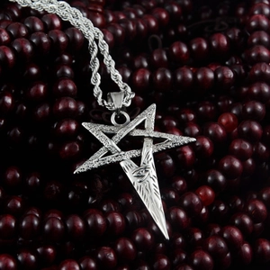 Detailed close-up of a silver pentagram pendant with Eye of Horus on wooden beads